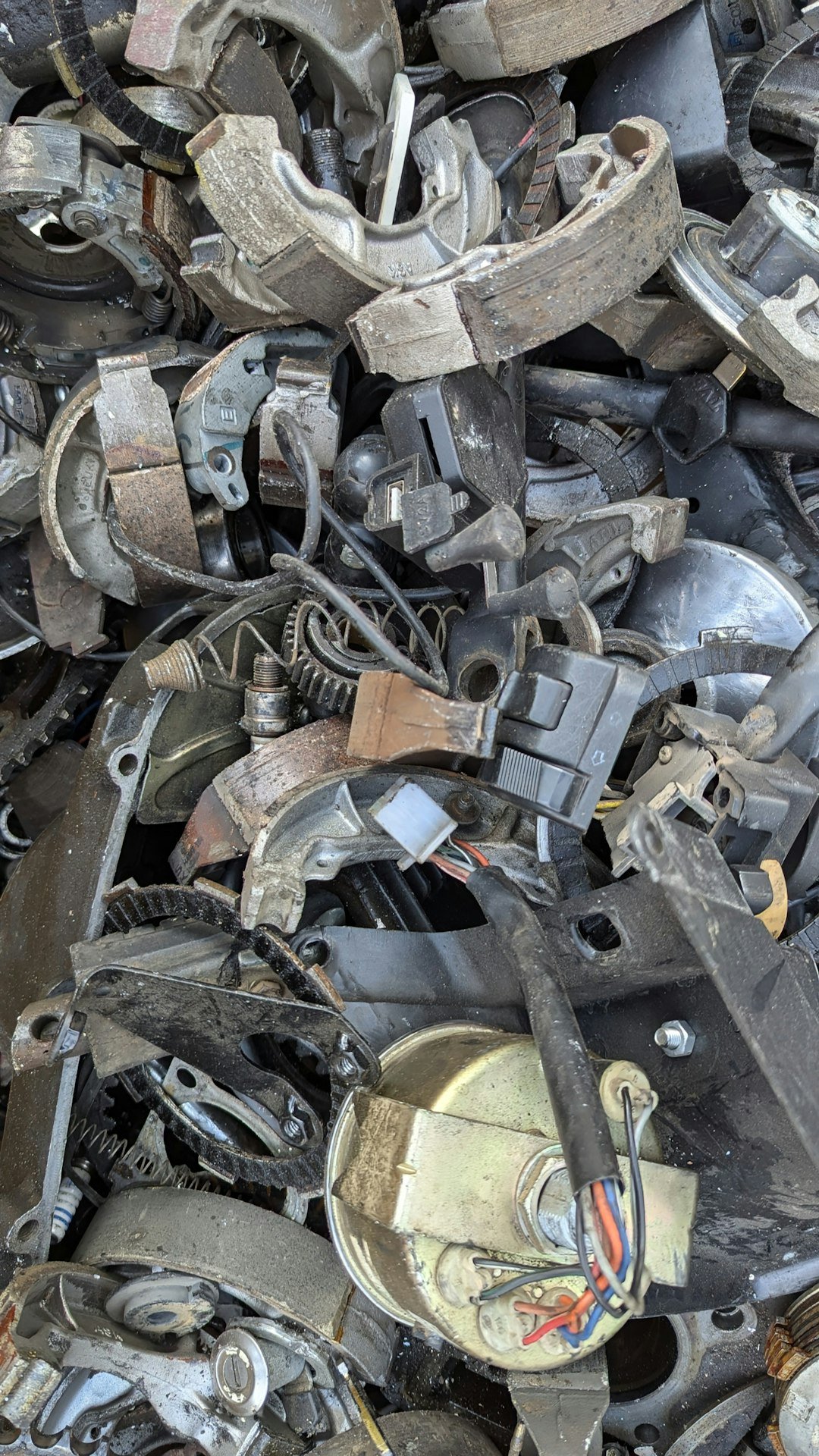 About a-pile-of-old-metal-parts-sitting-on-top-of-each-other-wlhychuqivy